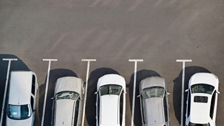 View from above of car parking full of vehicles.